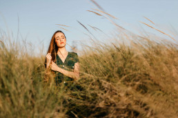 Woman with closed eyes standing in grass